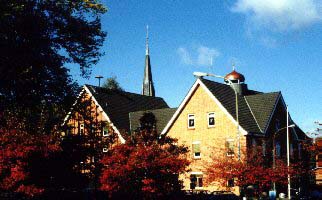 Town hall with church in
			background.